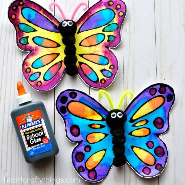 Picture of an example of a butterfly art craft using water colors and black glue to outline the butterfly