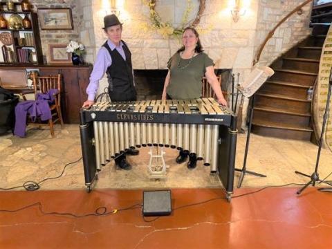 Man and woman standing infront of an electric piano