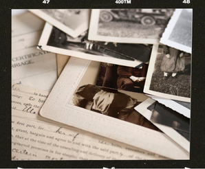 Black and white image of vintage photos and documents
