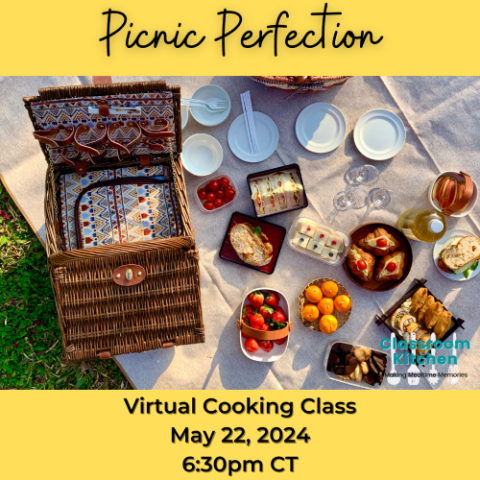 Picnic basket with various food laid out on a blanket