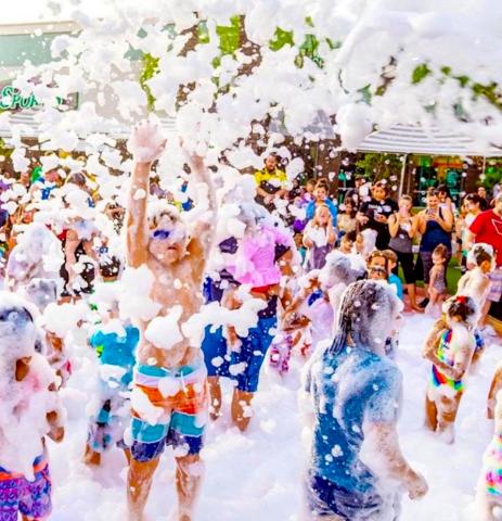Children playing at an outdoor foam party