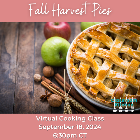 Apple pie on a wood table with apples and cinnamon