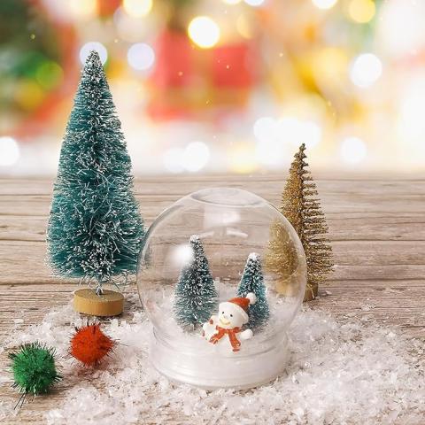 Picture of a plastic snow globe craft with two trees and a snowman