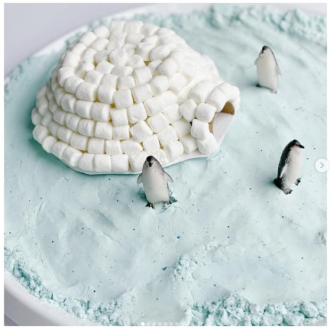 Picture of marshmallow igloo on fake snow with penguin figures