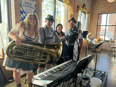 2 males and 2 females dressed in Oktoberfest costumes