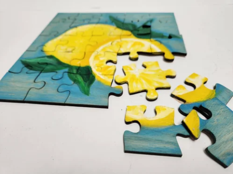 An image of a painting of lemons on a jigsaw puzzle.