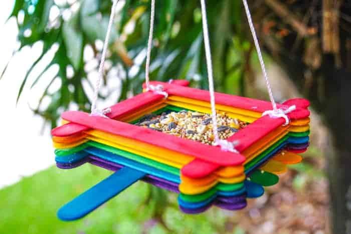 Picture of a handmade bird feeder with colorful popsicle sticks