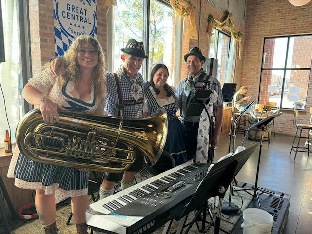 2 males and 2 females dressed in Oktoberfest costumes