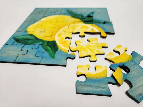 An image of a painting of lemons on a jigsaw puzzle.