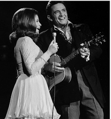 Black and white picture of June and Johnny Cash singing together